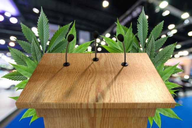 Podium with Cannabis leaves behind it
