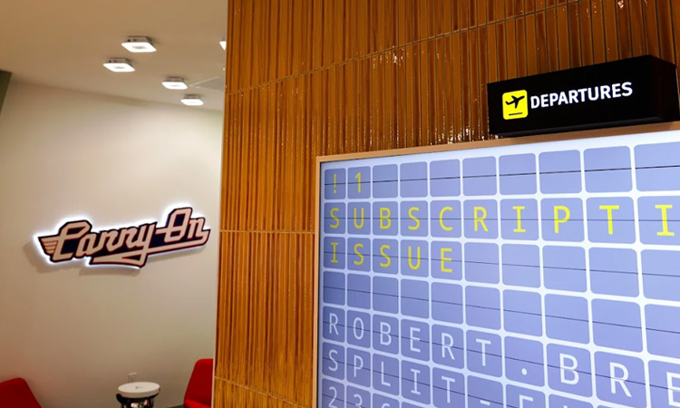 Interior of Carry-On Cannabis Dispensary featuring branded signage and an airport-style departures board, illustrating tailored marketing strategies for dispensary growth and customer retention.