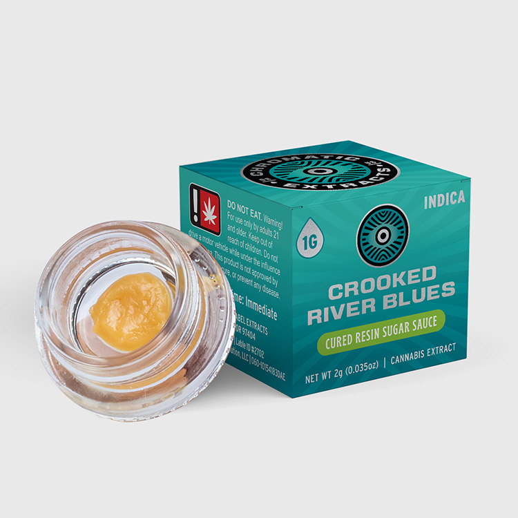 Crooked River Blues cured resin sugar sauce cannabis extract in a clear jar with teal branded packaging, highlighting compliant and eye-catching design for premium cannabis concentrates.