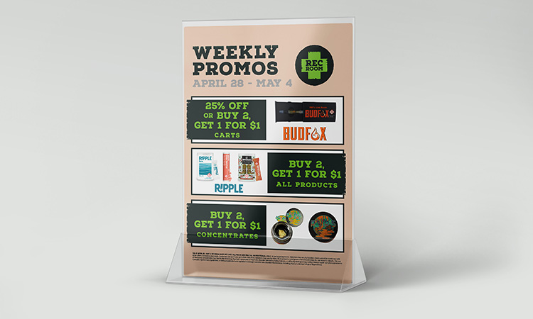 Point-of-sale table tent displaying weekly cannabis promotions for Rec Root from April 28–May 4, highlighting buy-one-get-one and percentage-off deals on carts, concentrates, and other products.